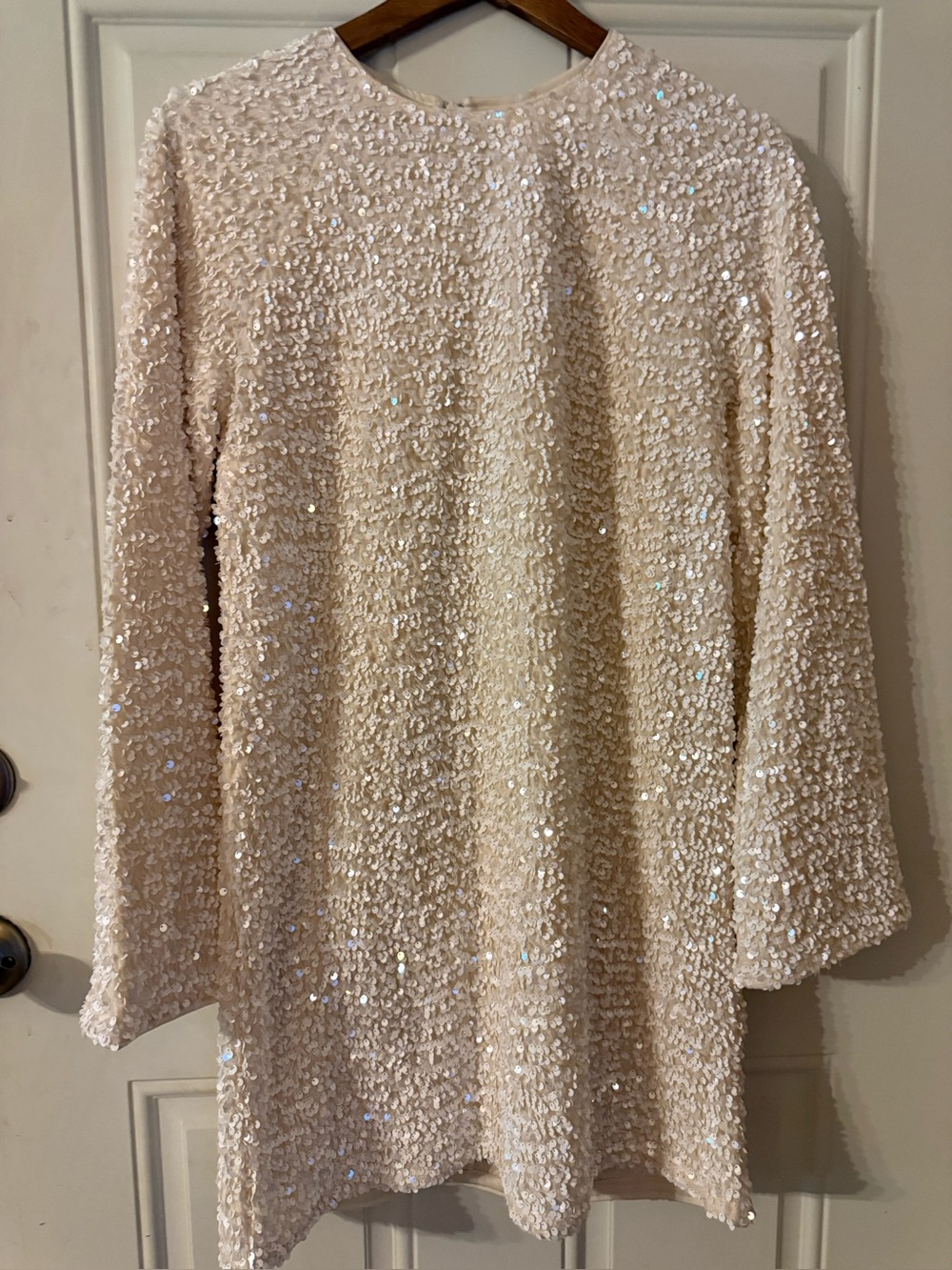 White H&M sequin mini dress featuring a round neckline and long sleeves. Sz S